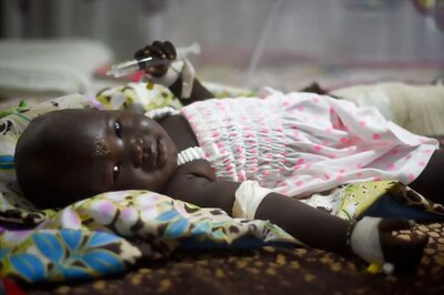 Thirteen-month-old baby in man's arms, the only two survivors of S Sudan plane crash