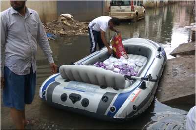 Residents of Flooded Hyderabad Colony are Using Boats to Deliver Food to Water-logged Homes