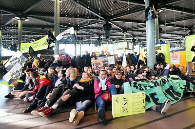 Police Drag Environmental Protesters from Hall of Amsterdam Airport
