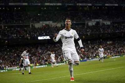 Real Madrid thump nine-man Malaga to delay Barca title