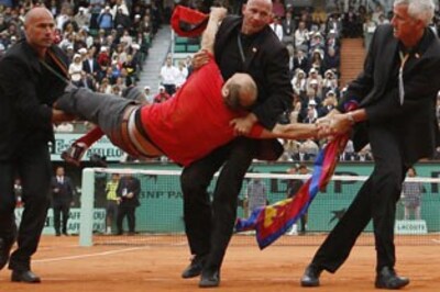 French Open: Man runs onto court towards Federer