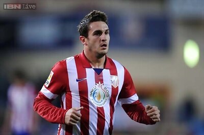 Atletico win at Malaga to become overnight Spanish leader